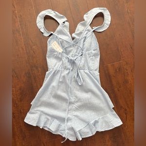 NWT!! Small romper with ruffles and strap ties on back.